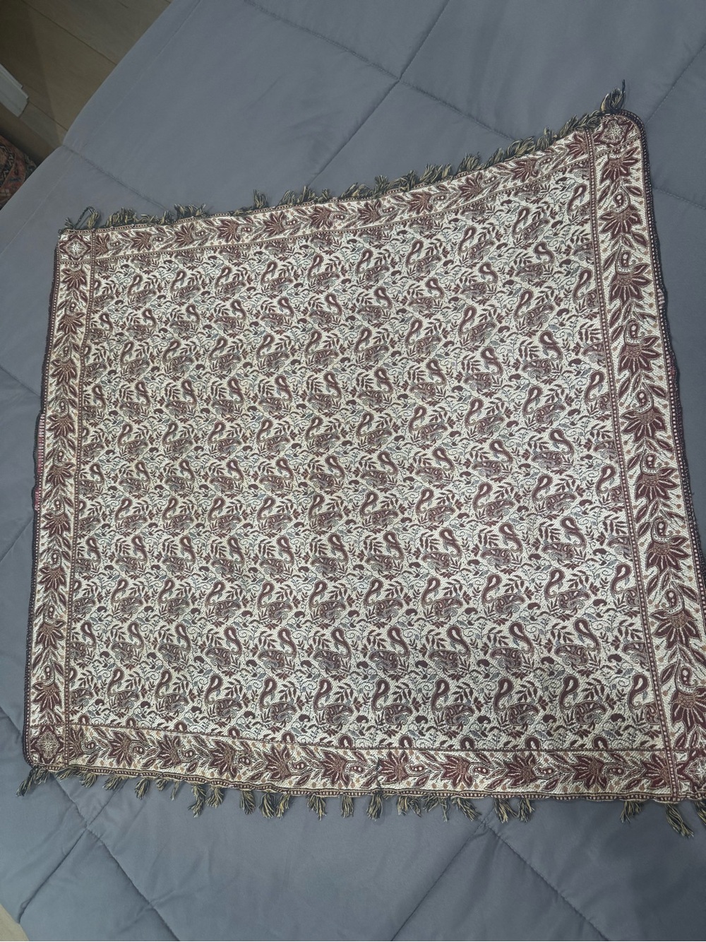 vintage woven textile with an intricate paisley and floral design in rich brown,